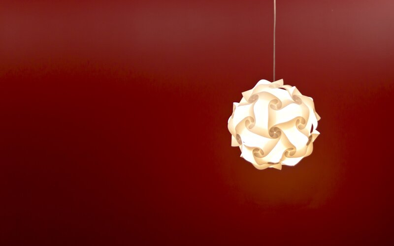 white lampshade against red wall
