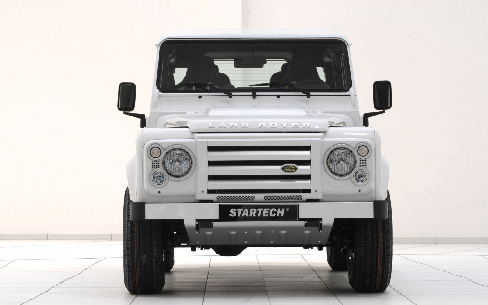 white land rover defender