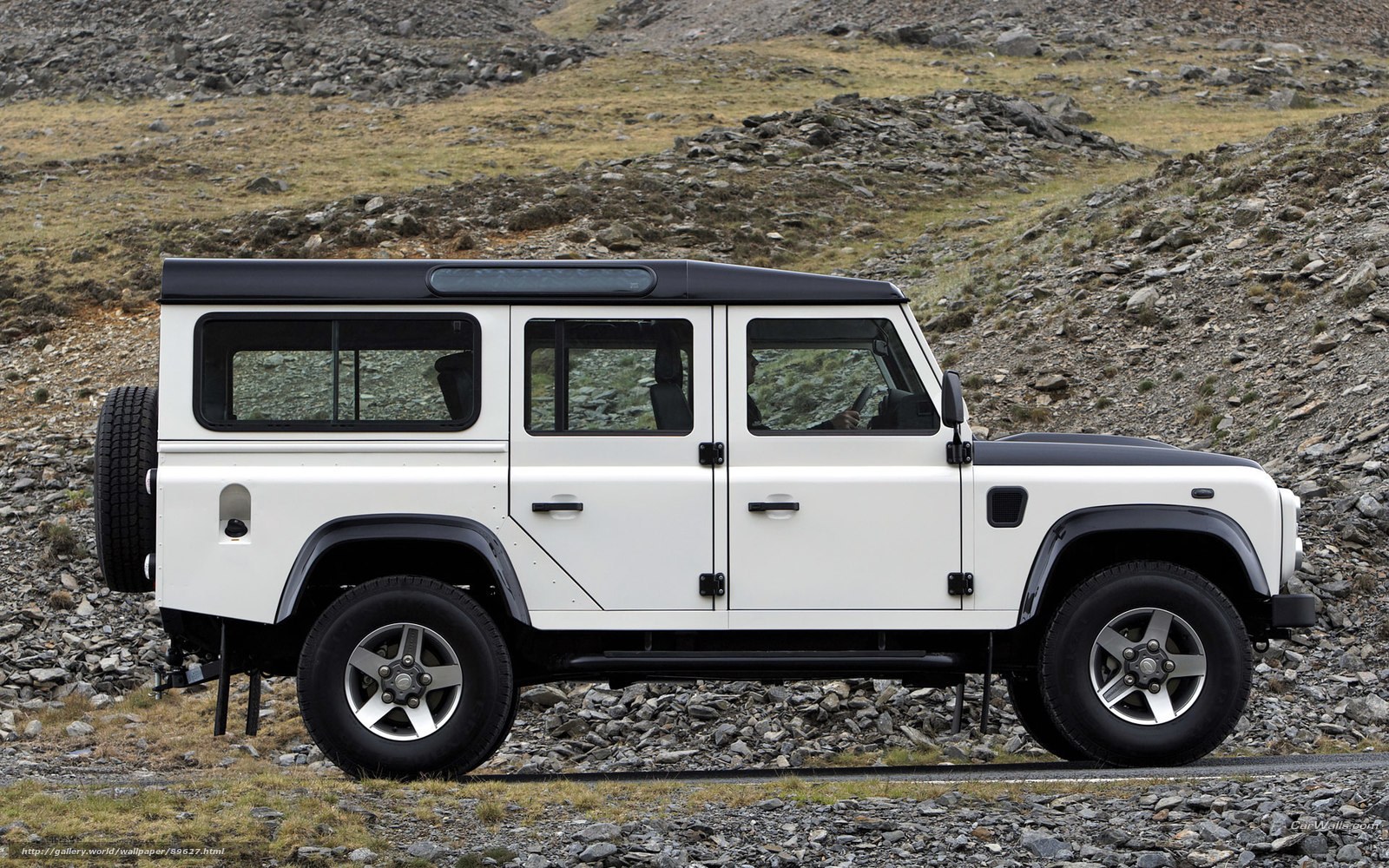 white land rover in rocky terrain