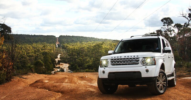 White Land Rover on dirt road