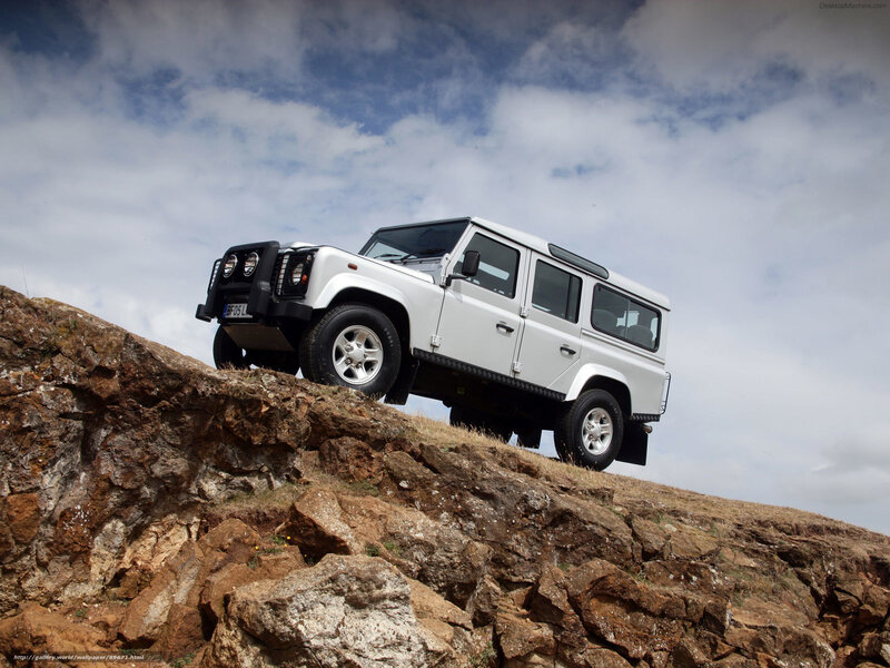 white land rover on rocky hill