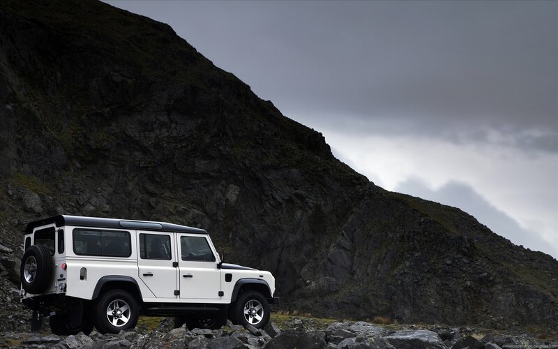 White Land Rover on rocky hillside