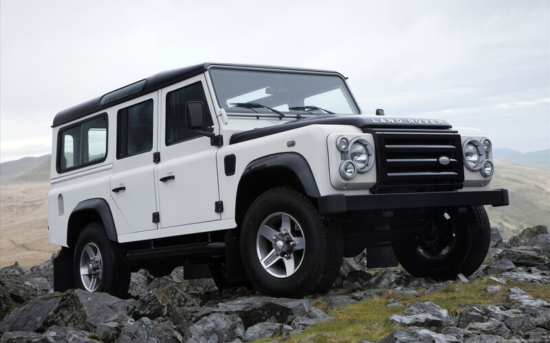 White Land Rover on rocky terrain