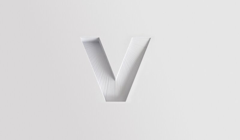 white letter V on gray background