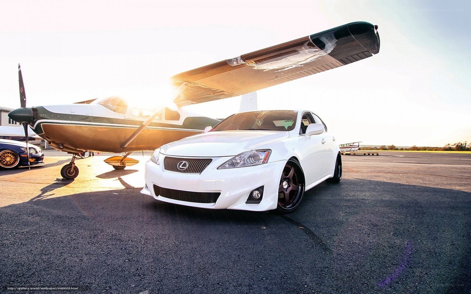 White Lexus on tarmac with plane