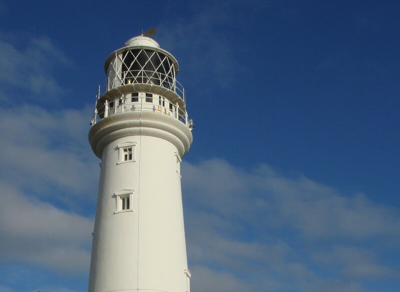 White lighthouse against blue sky
