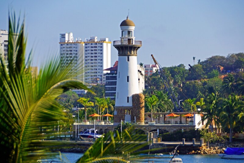 White Lighthouse by Water — Blue, Serene, Afternoon