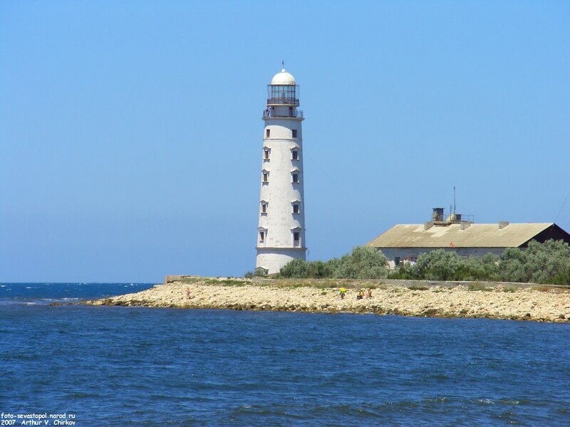 White Lighthouse on Coast — Blue
