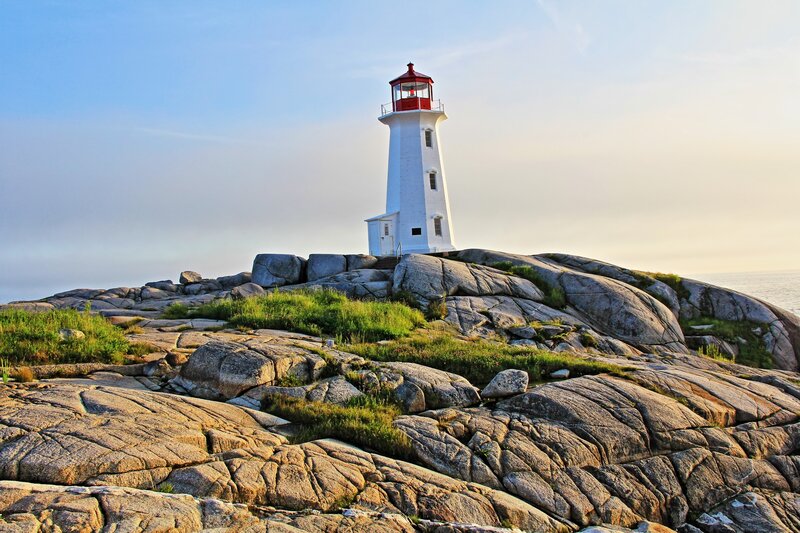 White Lighthouse on Rocks — Serene, Sunset