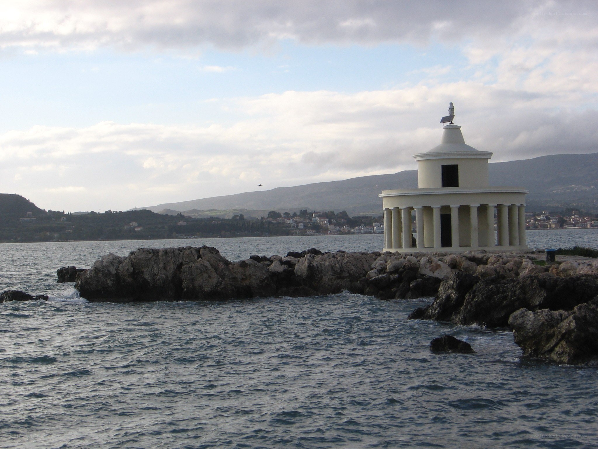 White lighthouse on rocky pier