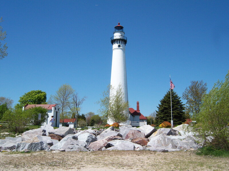 White lighthouse on rocky shore