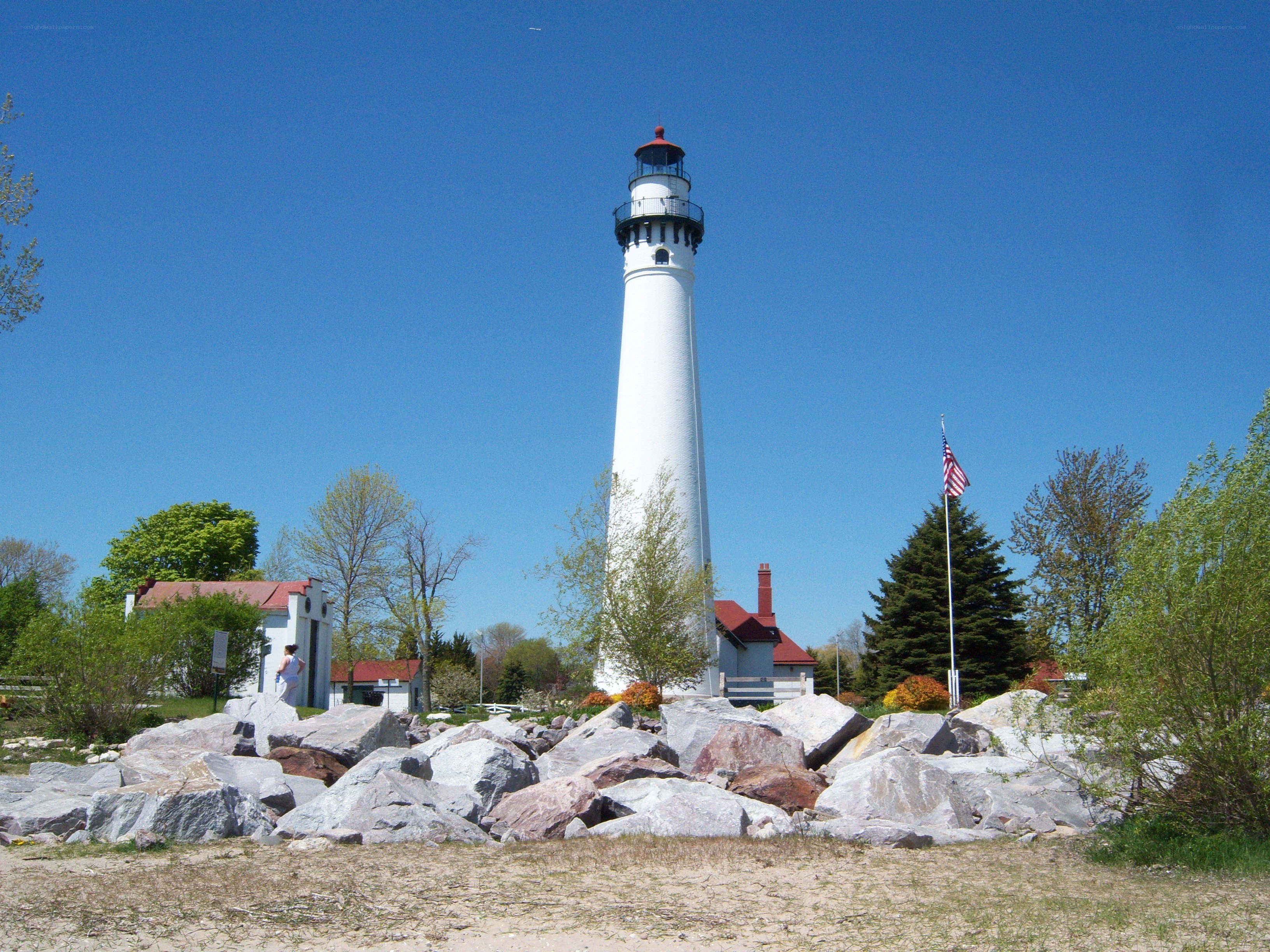 White lighthouse on rocky shore