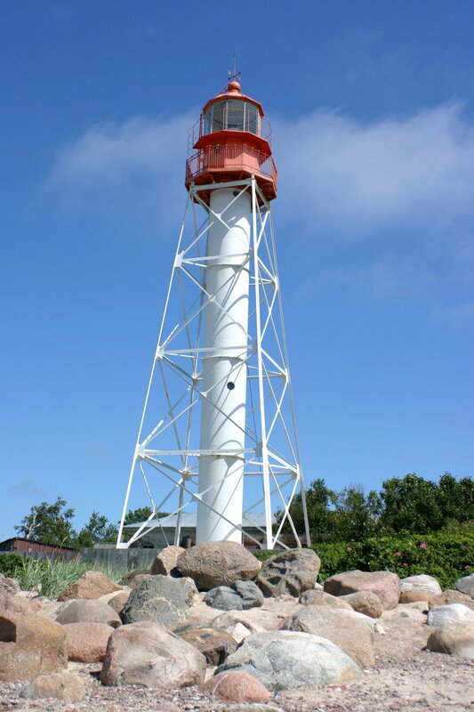 White lighthouse on rocky shore