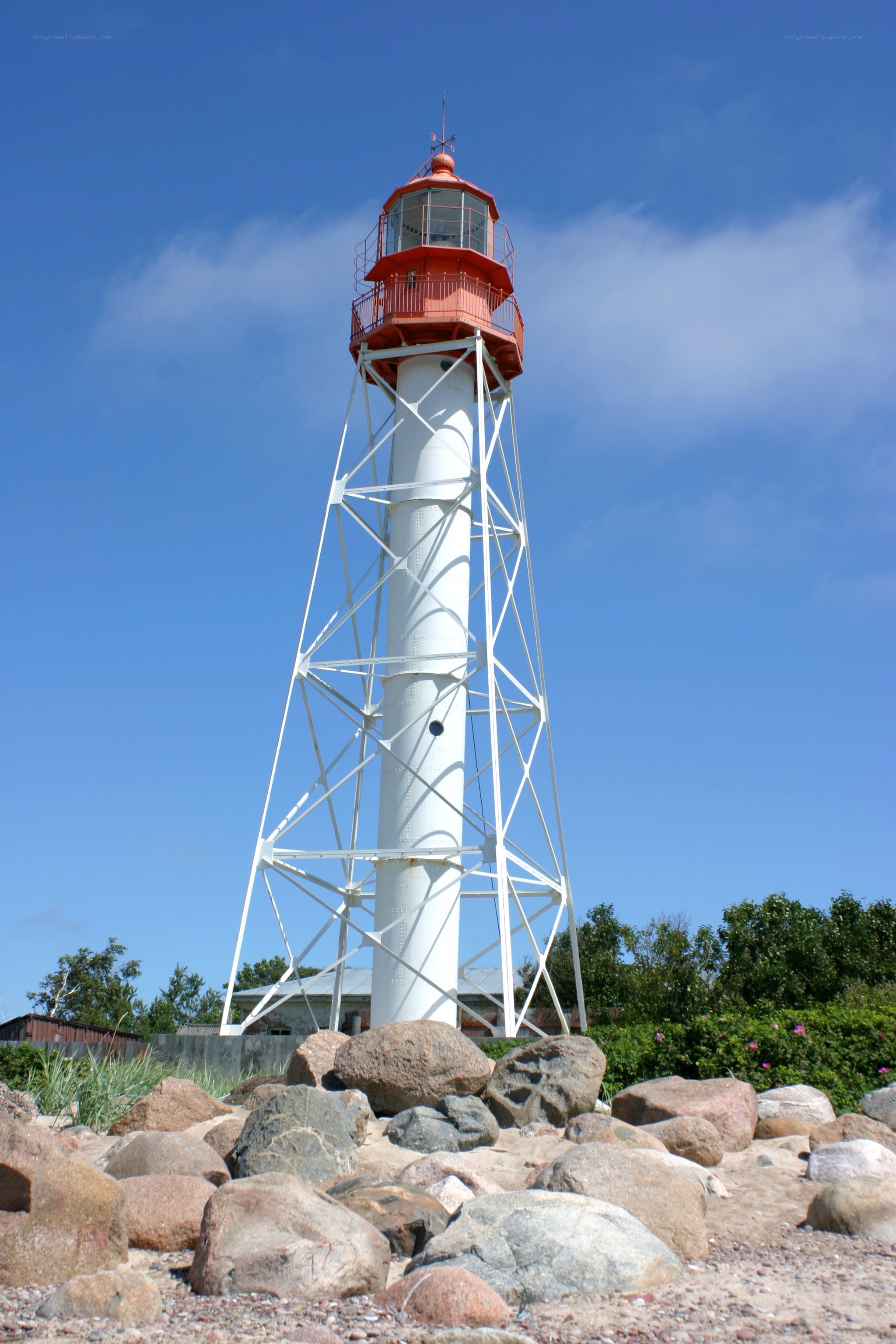 White lighthouse on rocky shore
