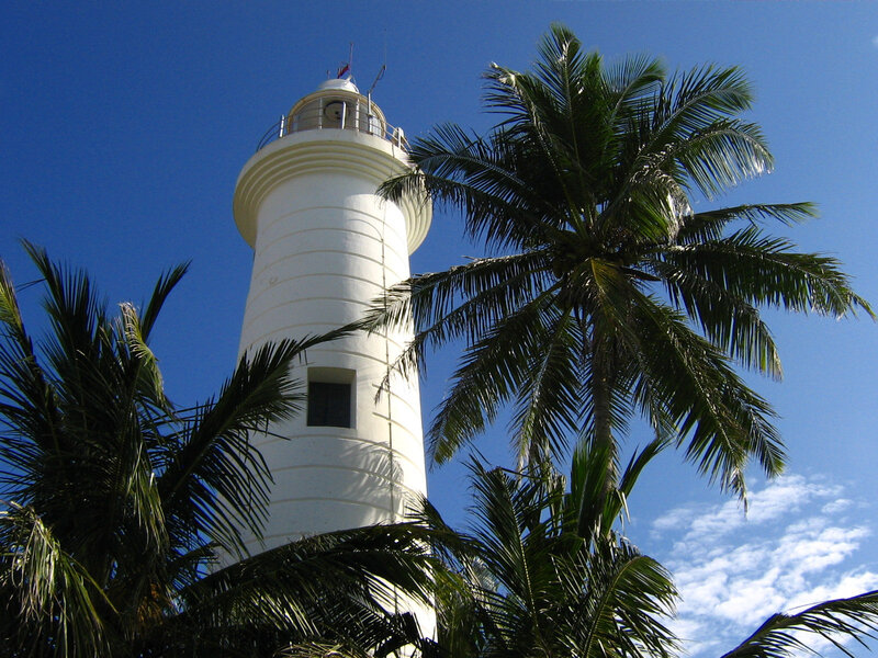 White lighthouse with palm trees