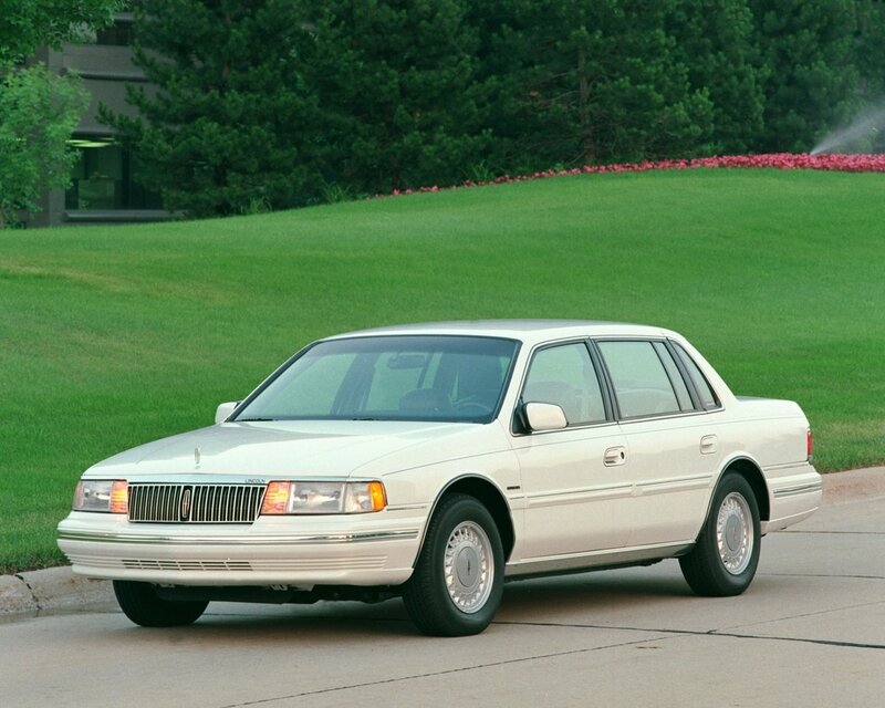 white lincoln sedan on driveway