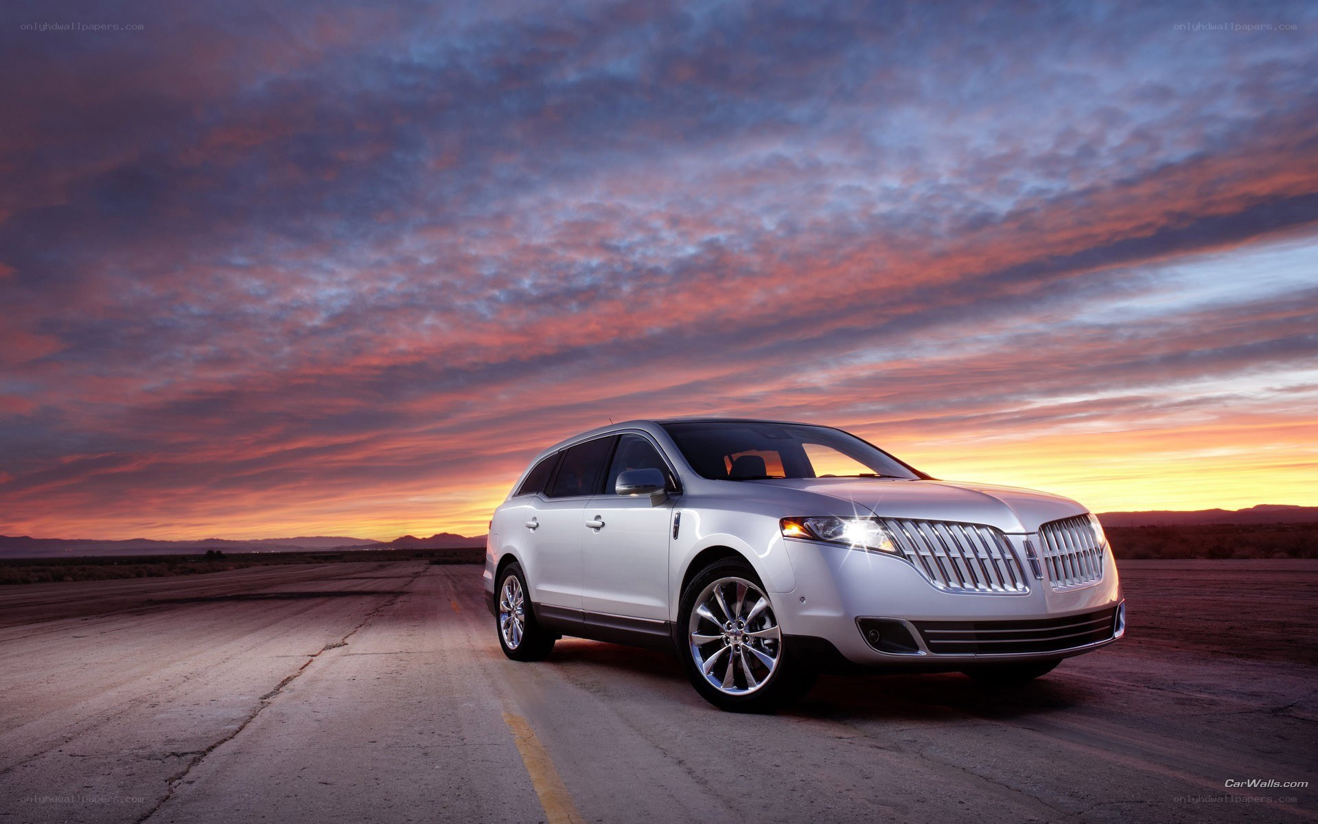 White Lincoln SUV at sunset