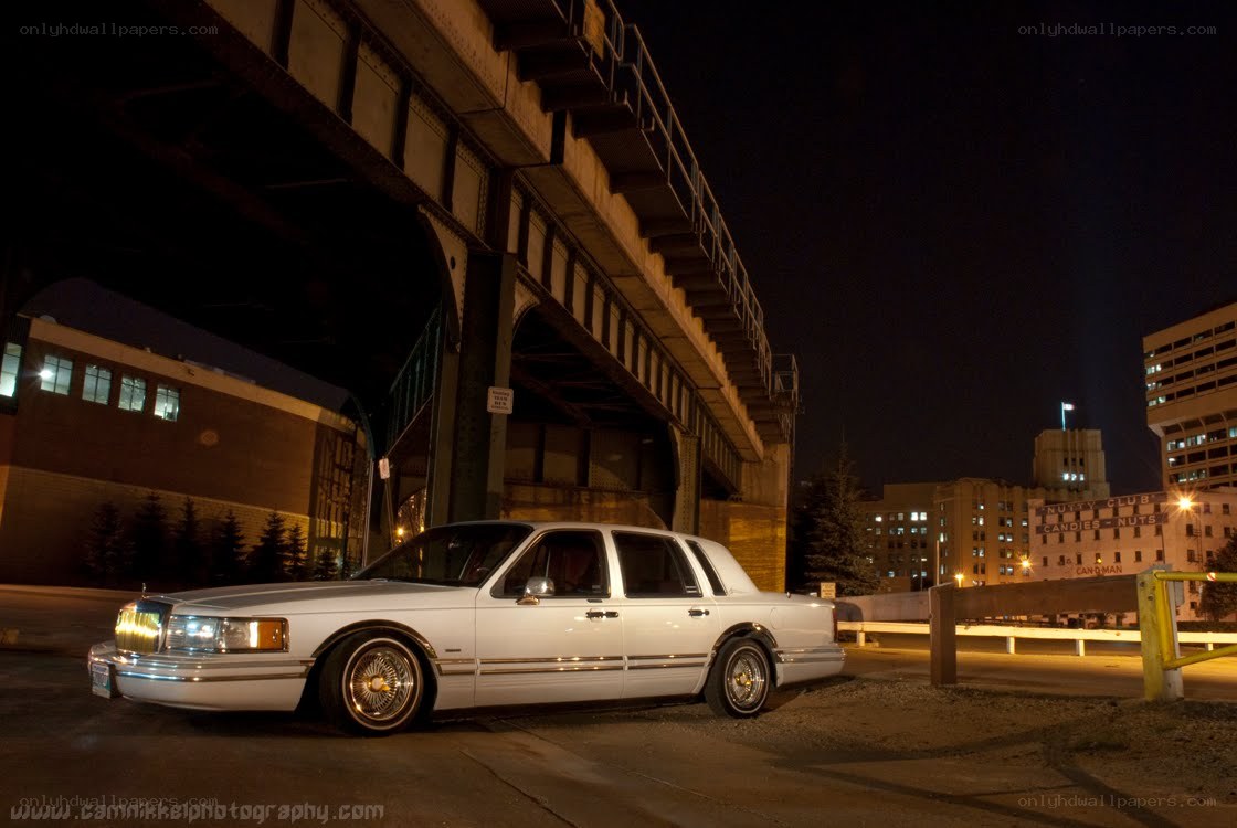 white lincoln under bridge at night