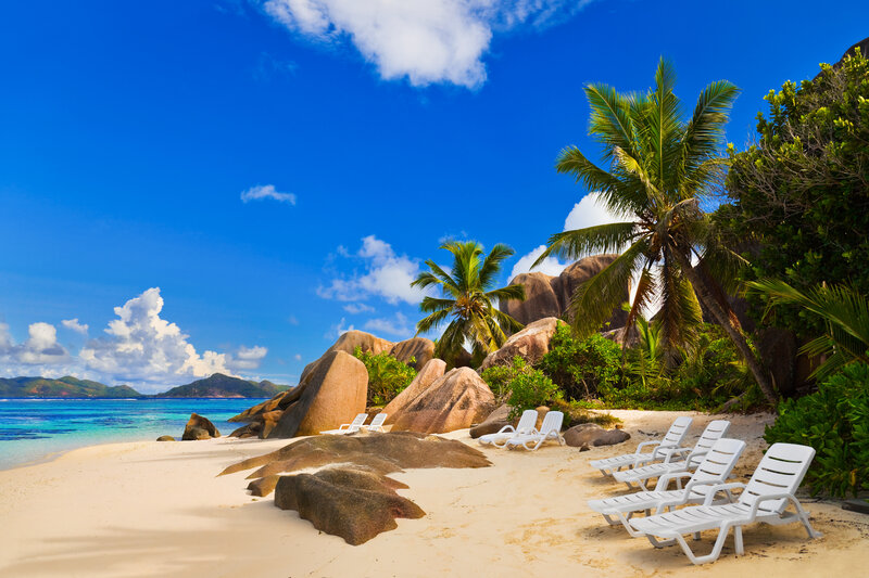 White Lounge Chairs on Beach