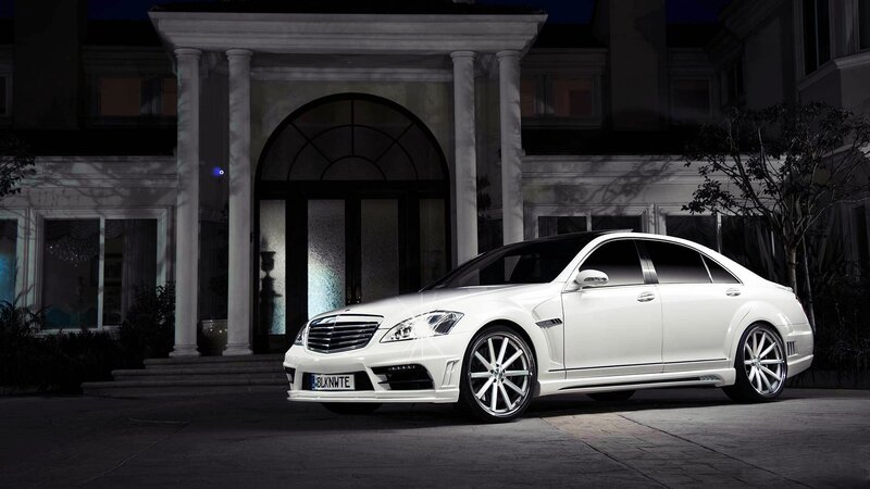 White luxury sedan at mansion