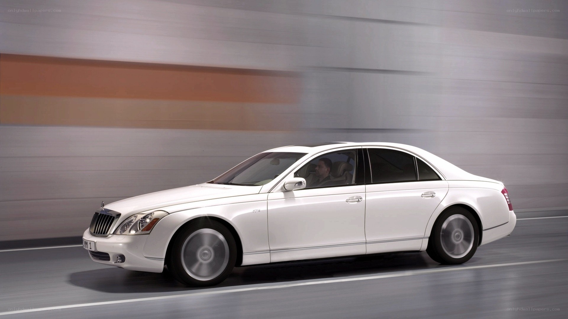 white luxury sedan in motion