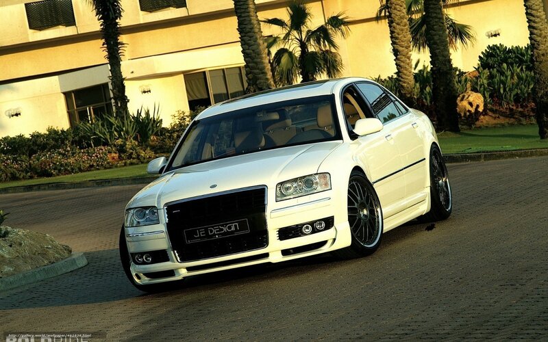 white luxury sedan on driveway