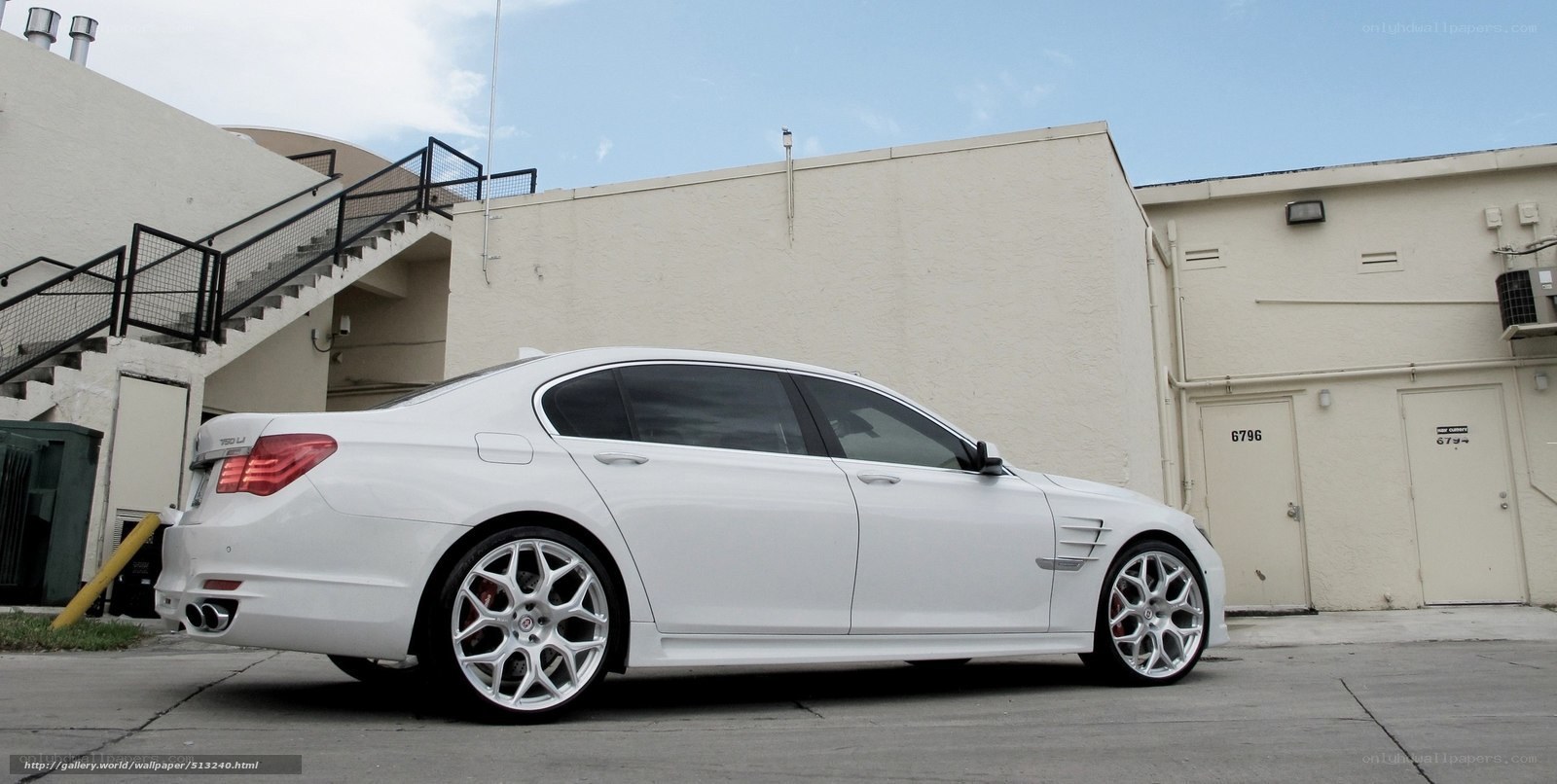 white luxury sedan parked