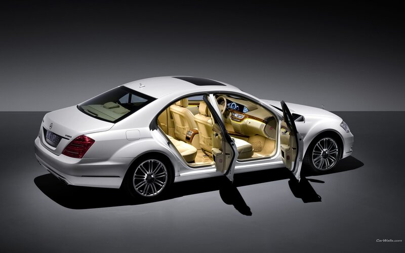 White luxury sedan with open doors
