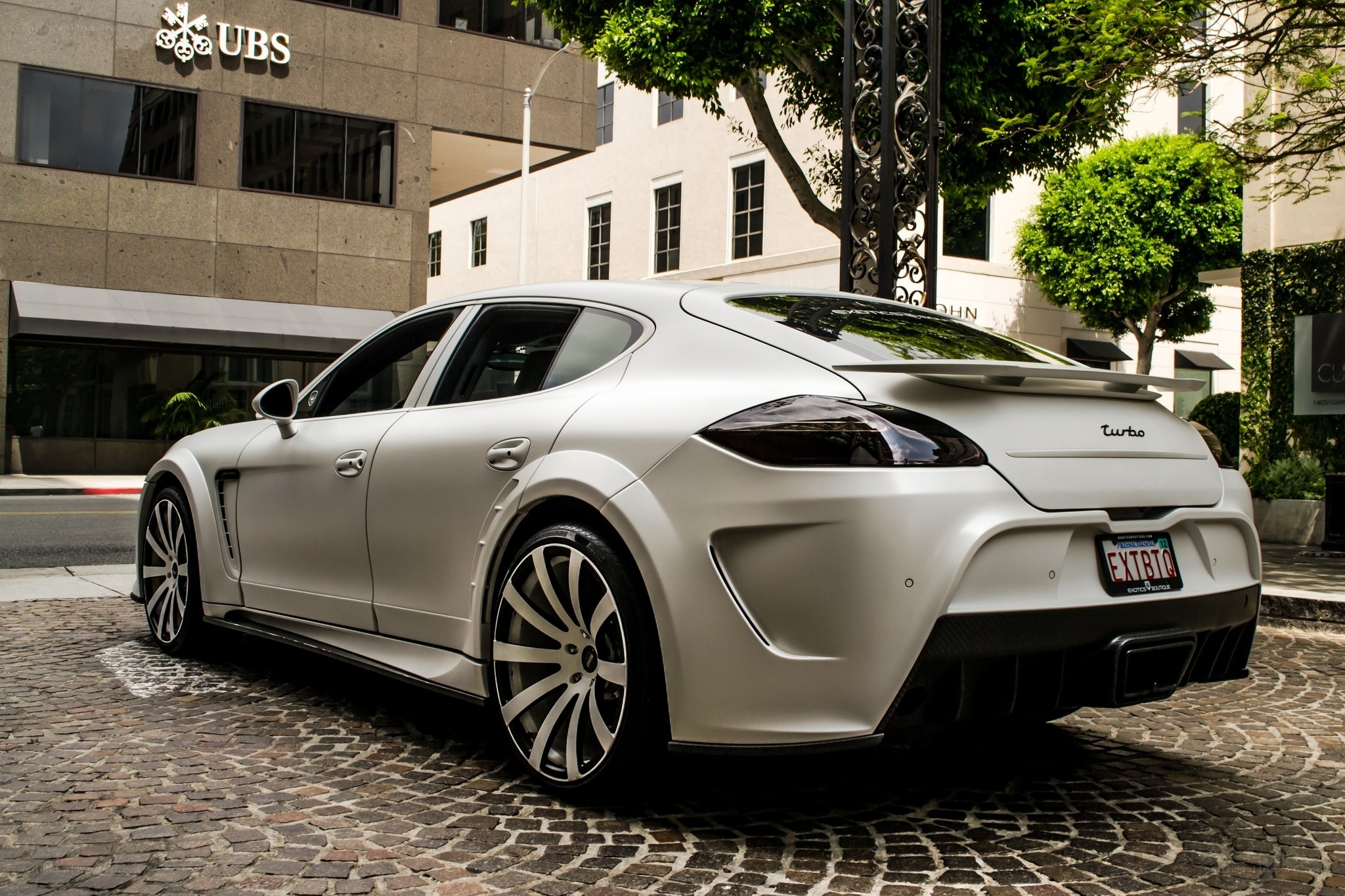 White luxury sports car on cobblestone