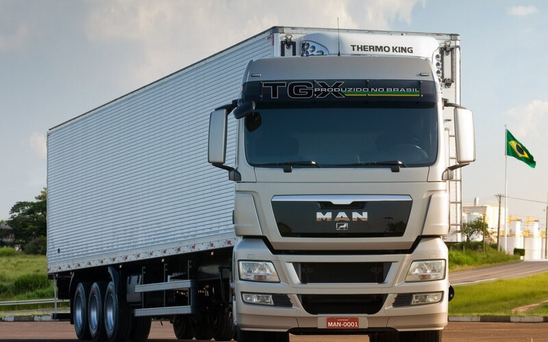 White MAN TGX truck with trailer