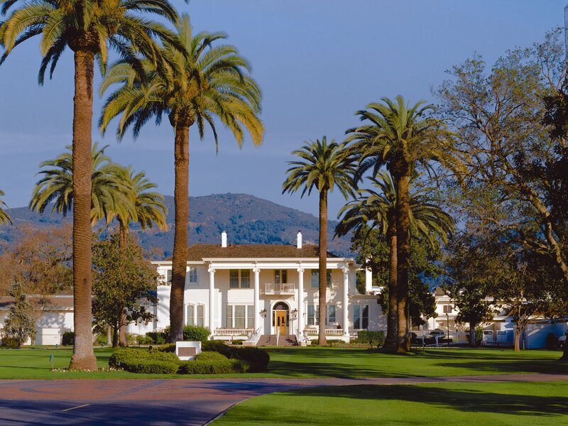 White mansion with palm trees