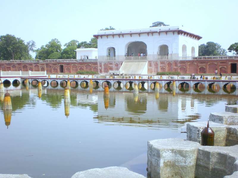 white marble pavilion by a pool