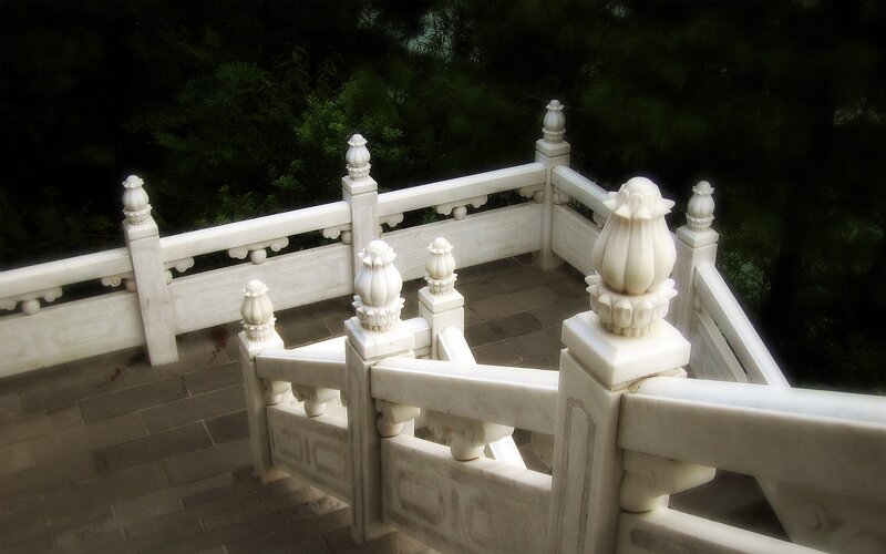 white marble railing with lotus carvings