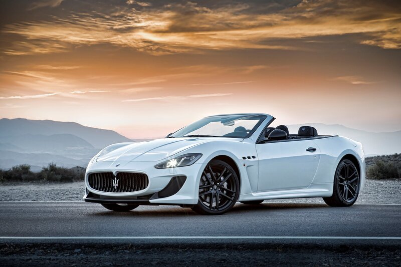 White Maserati convertible at sunset