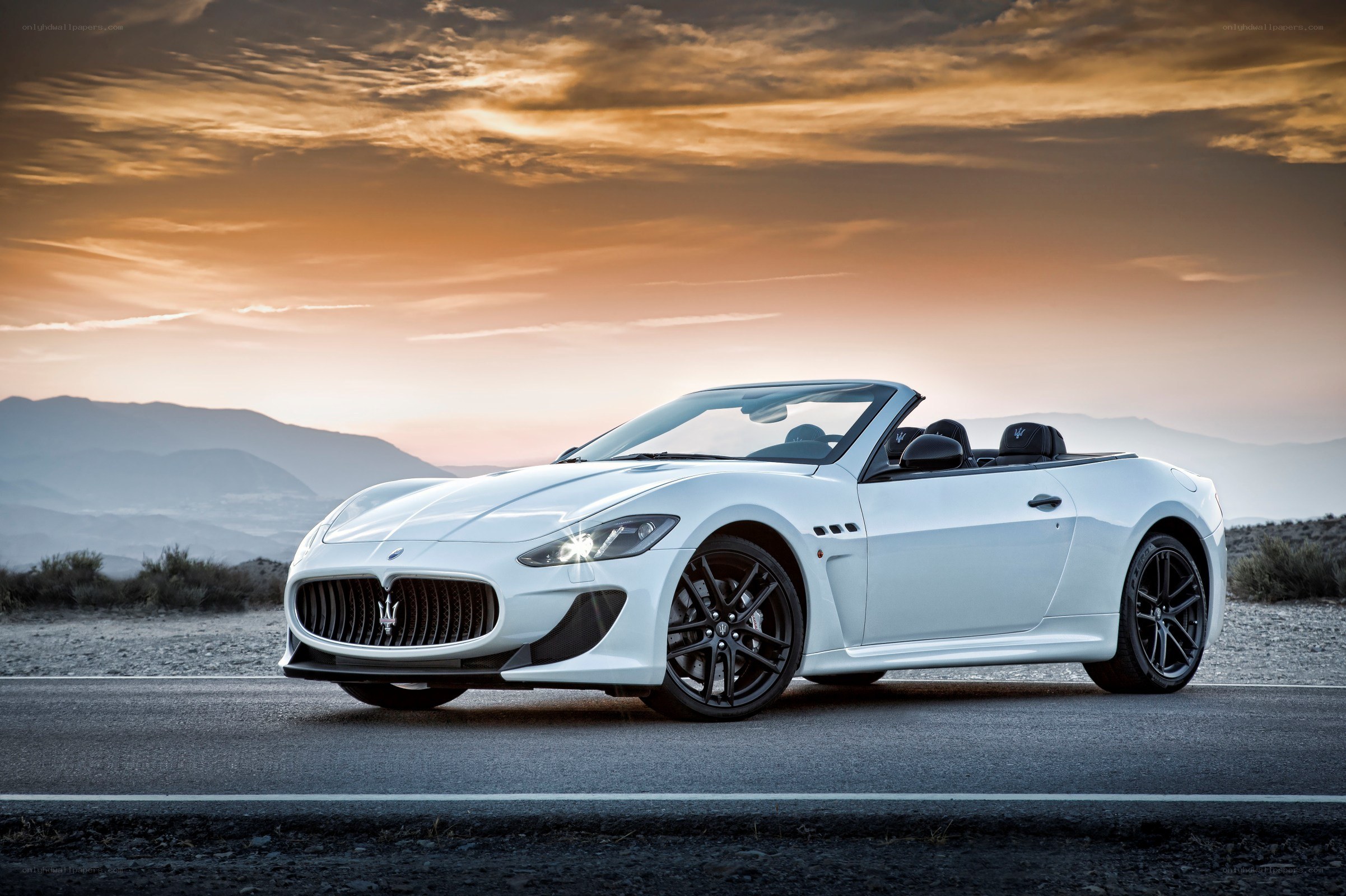 White Maserati convertible at sunset
