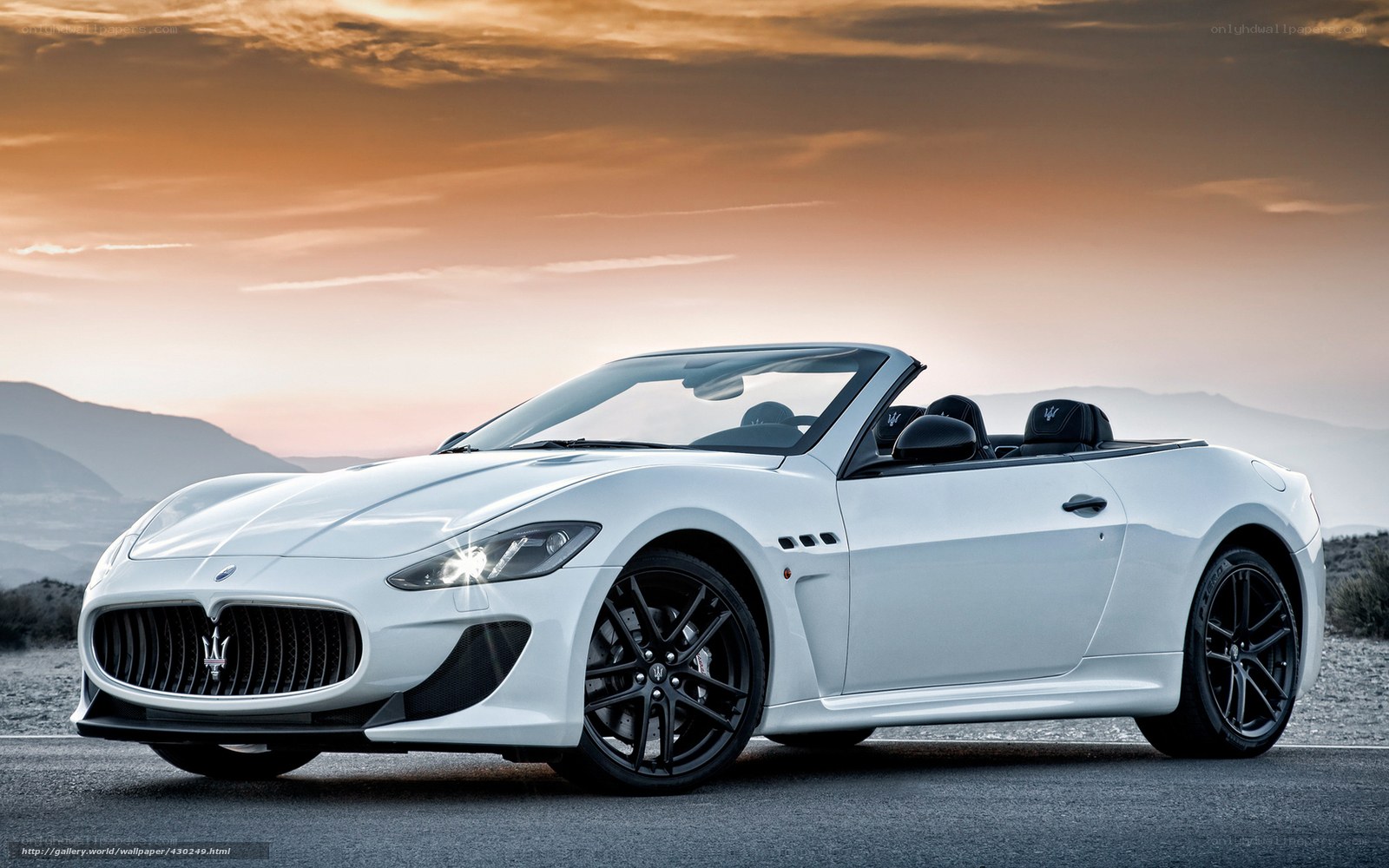 White Maserati convertible at sunset