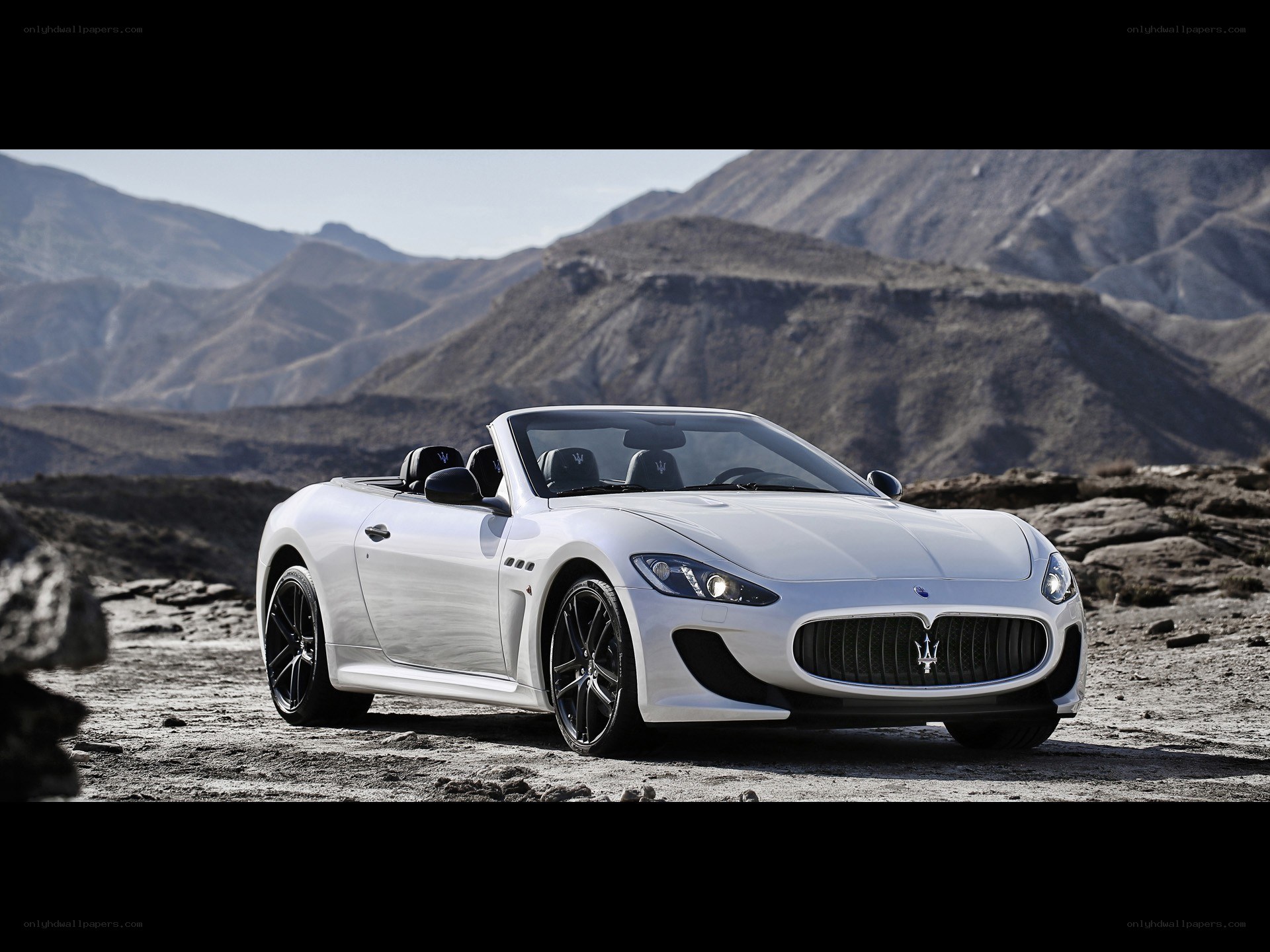 White Maserati convertible in desert