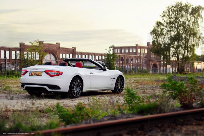 White Maserati convertible in industrial area