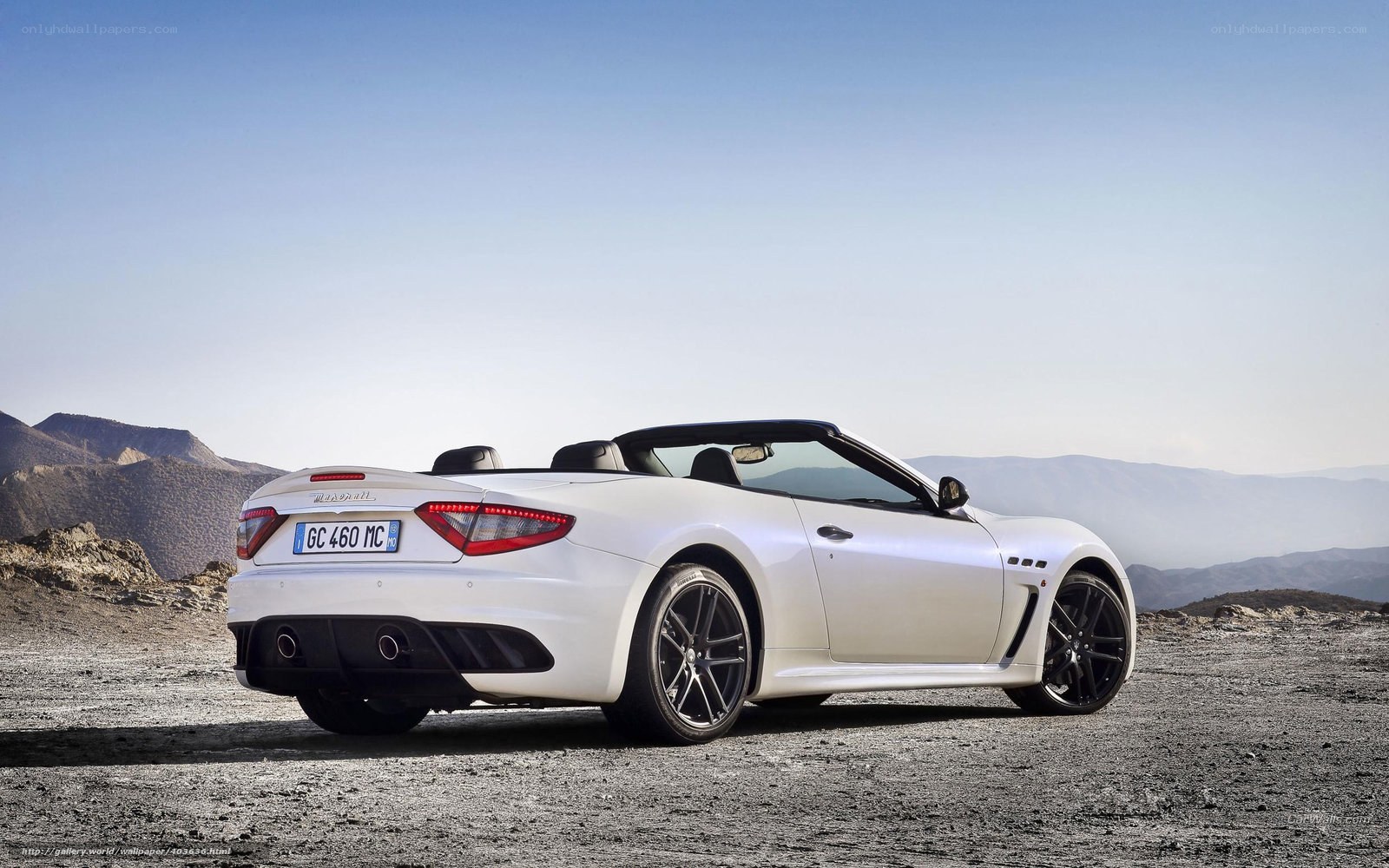 White Maserati convertible on mountain road