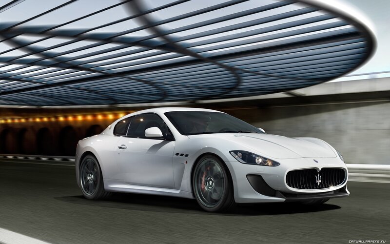 white Maserati driving in tunnel
