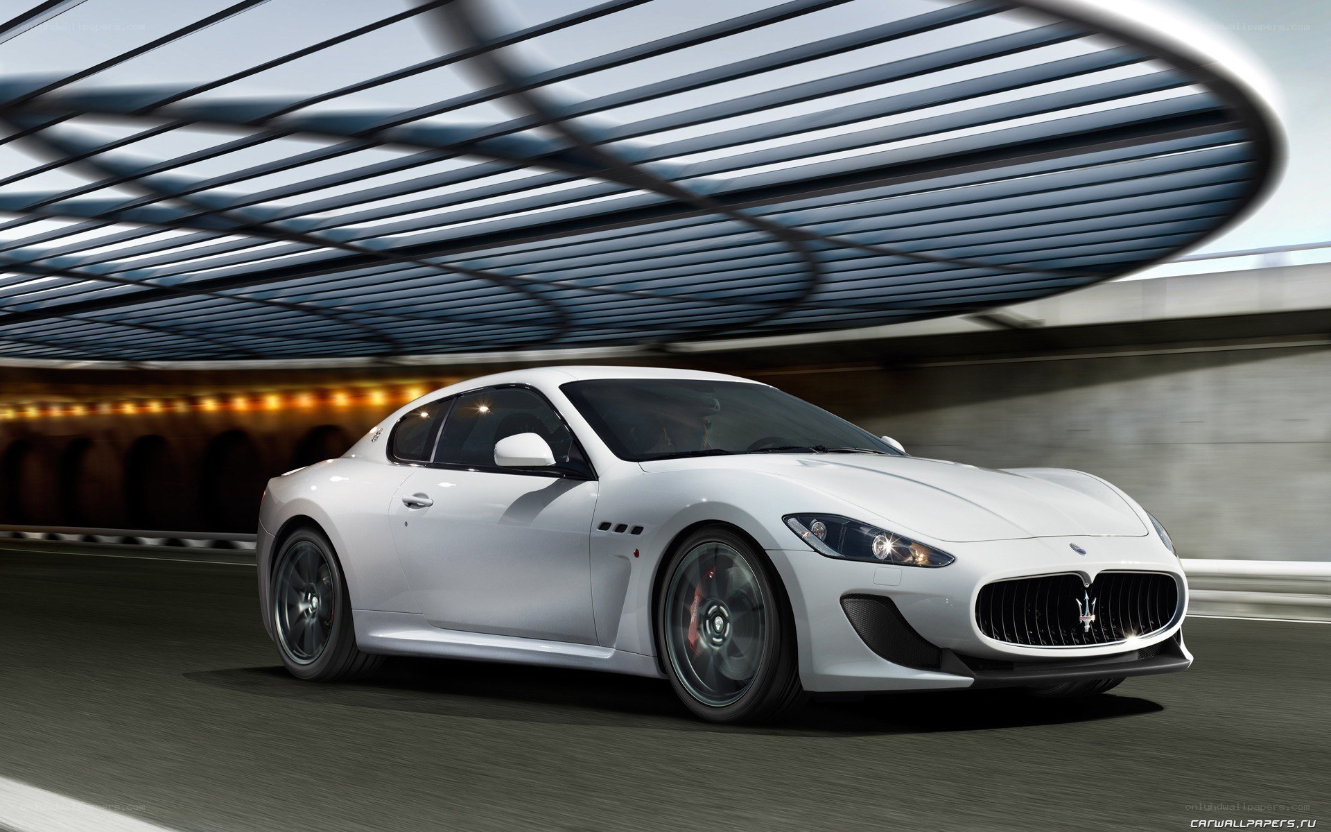 white Maserati driving in tunnel