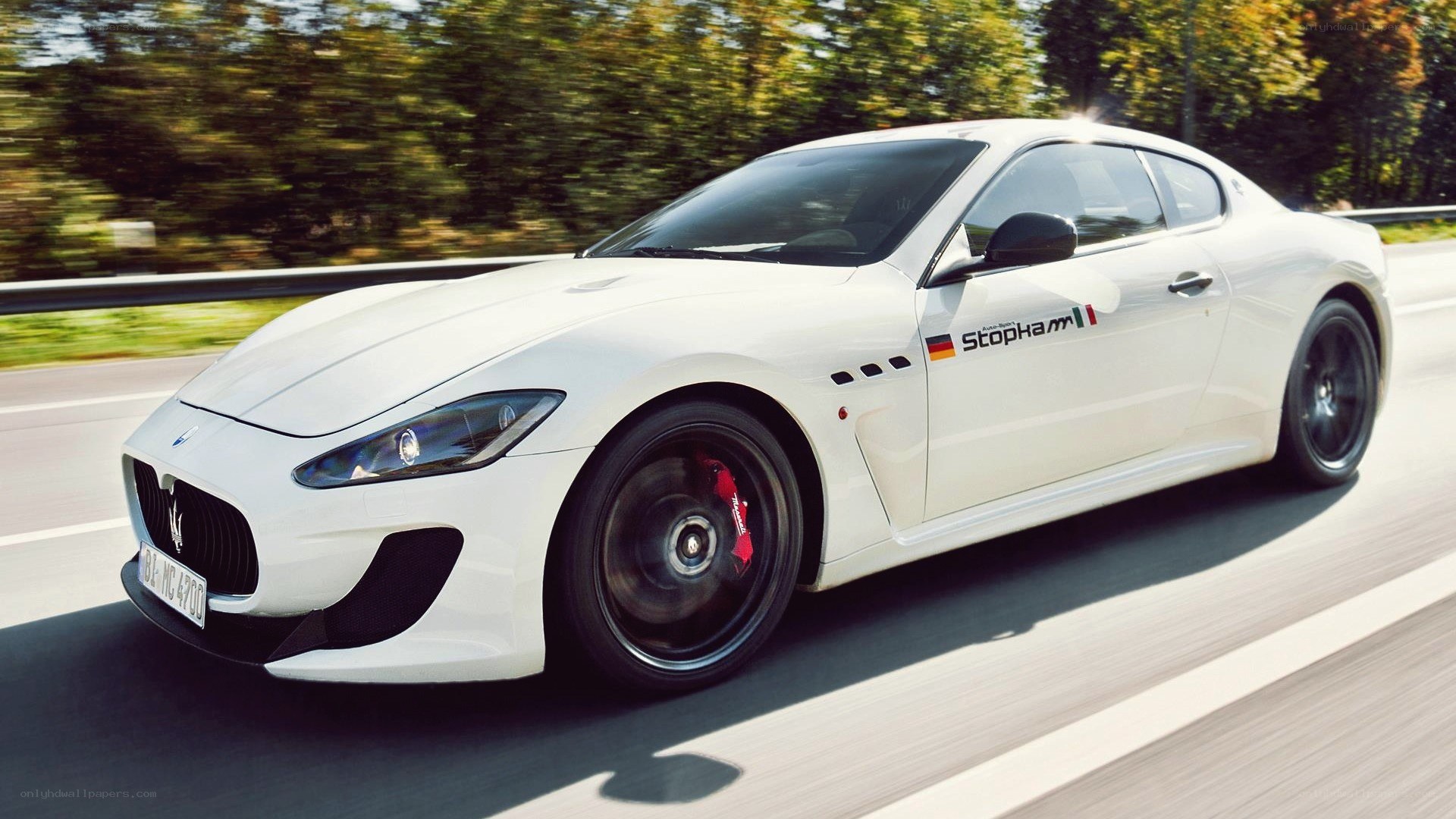 white Maserati driving on road