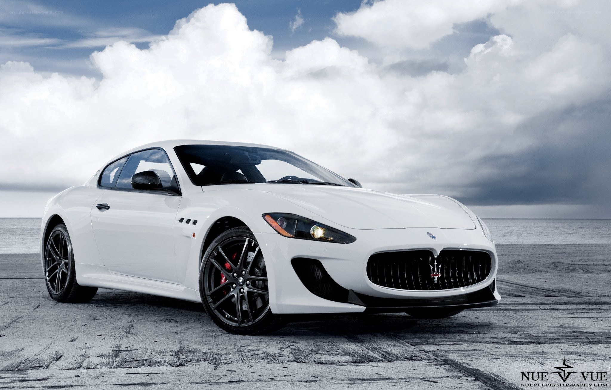 White Maserati on a beach