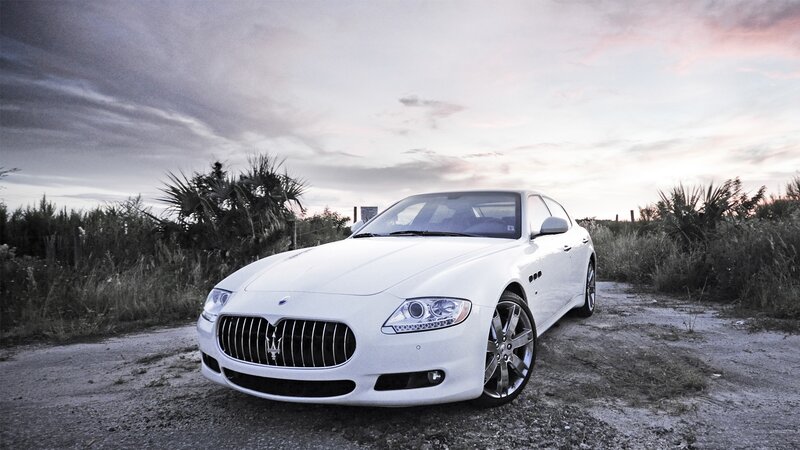 White Maserati on a dirt road