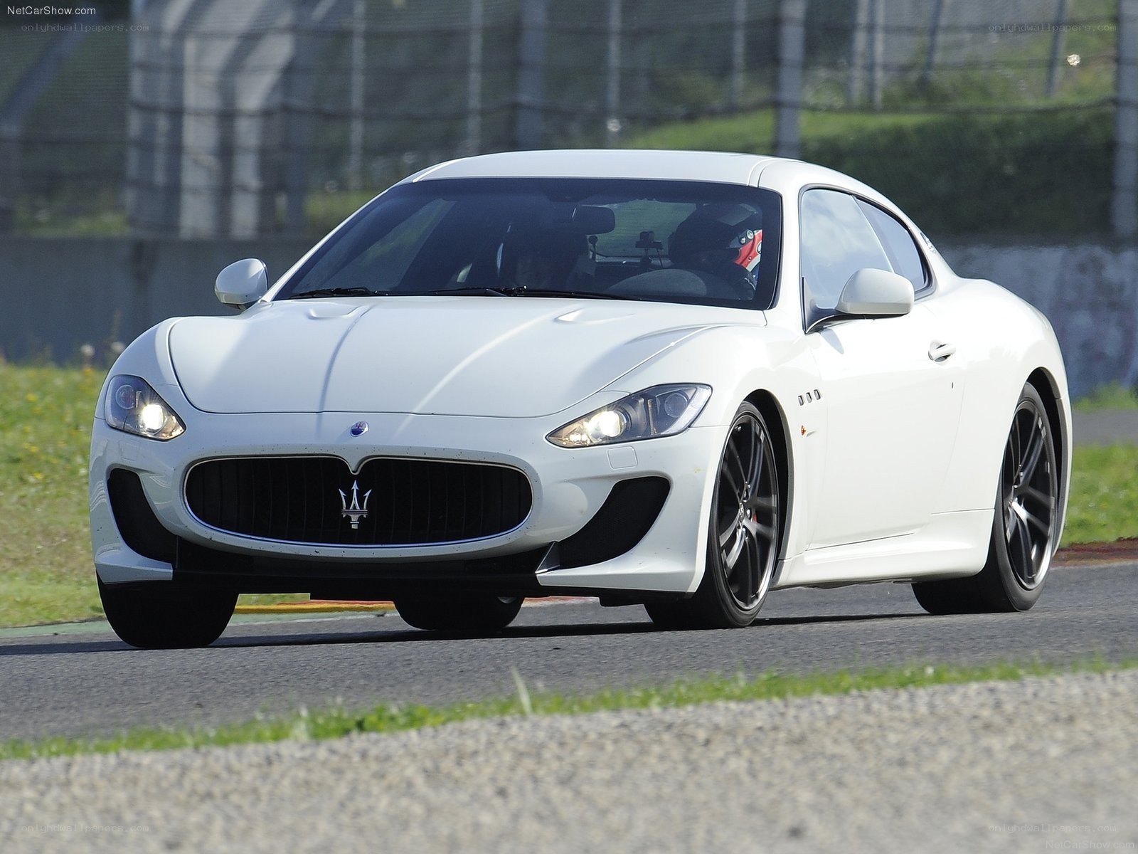 White Maserati on a racetrack