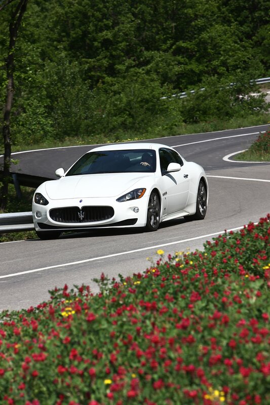 White Maserati on a winding road