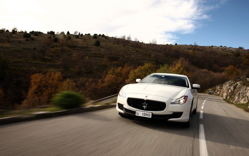 White Maserati on a winding road