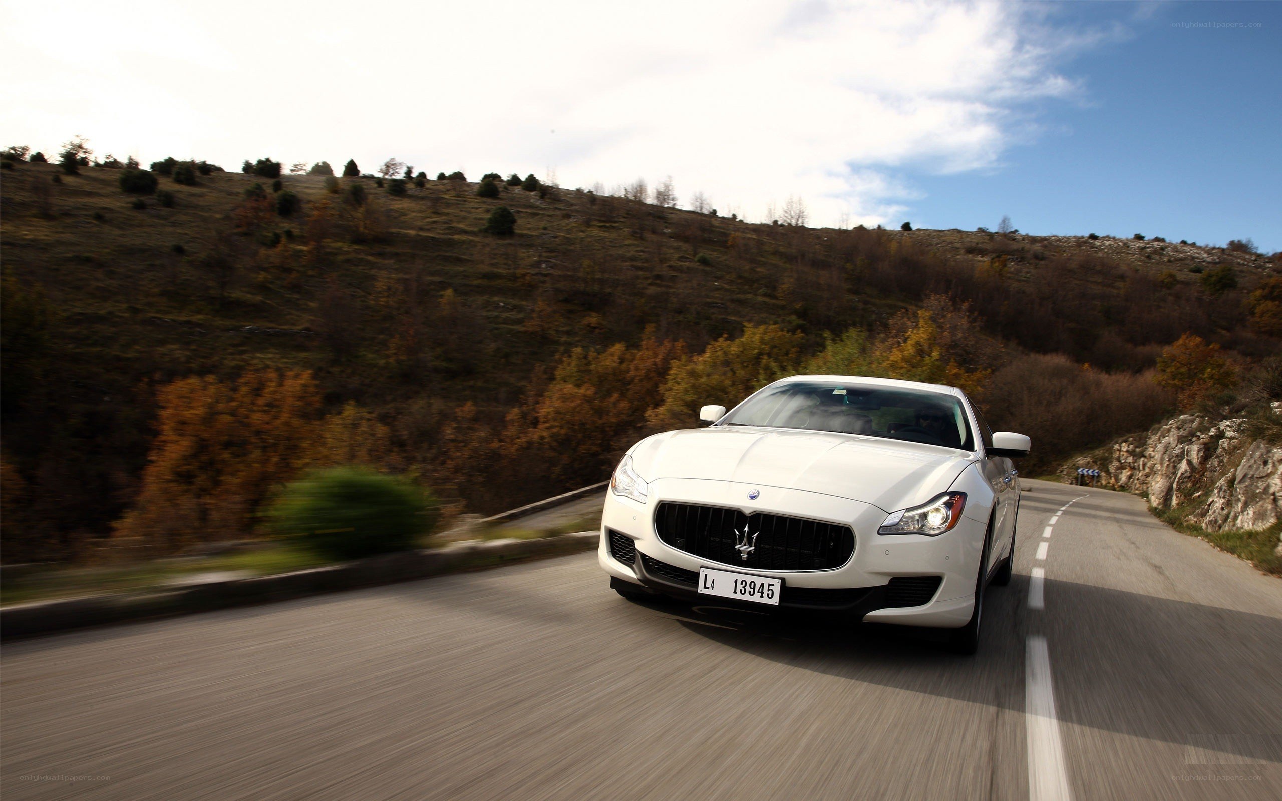 White Maserati on a winding road