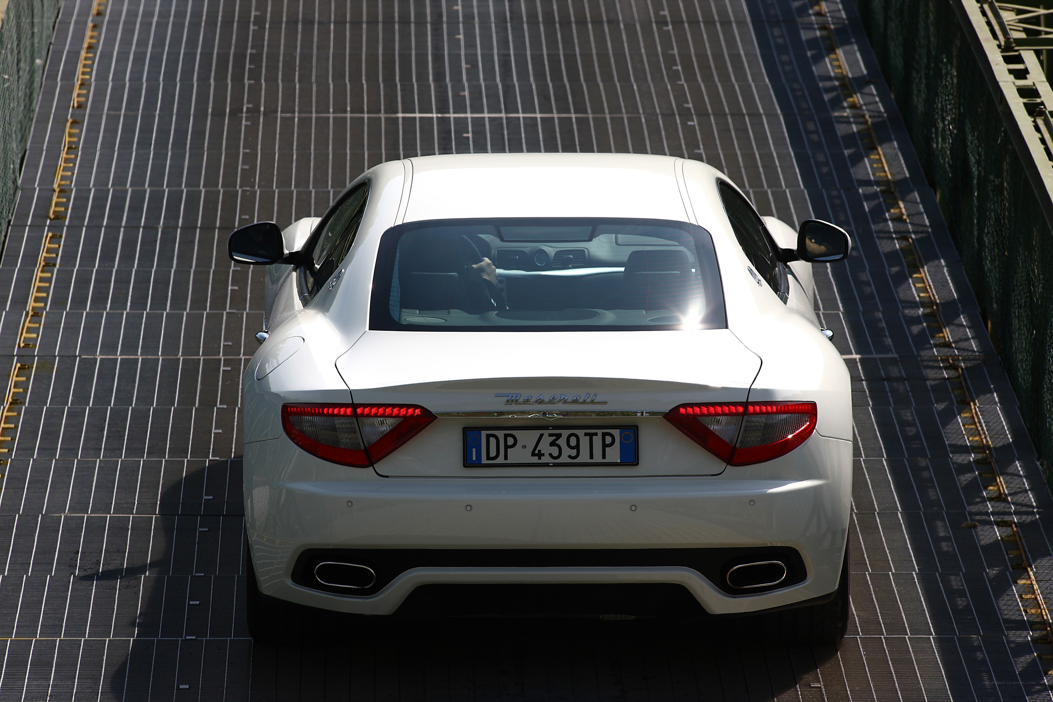 White Maserati on bridge