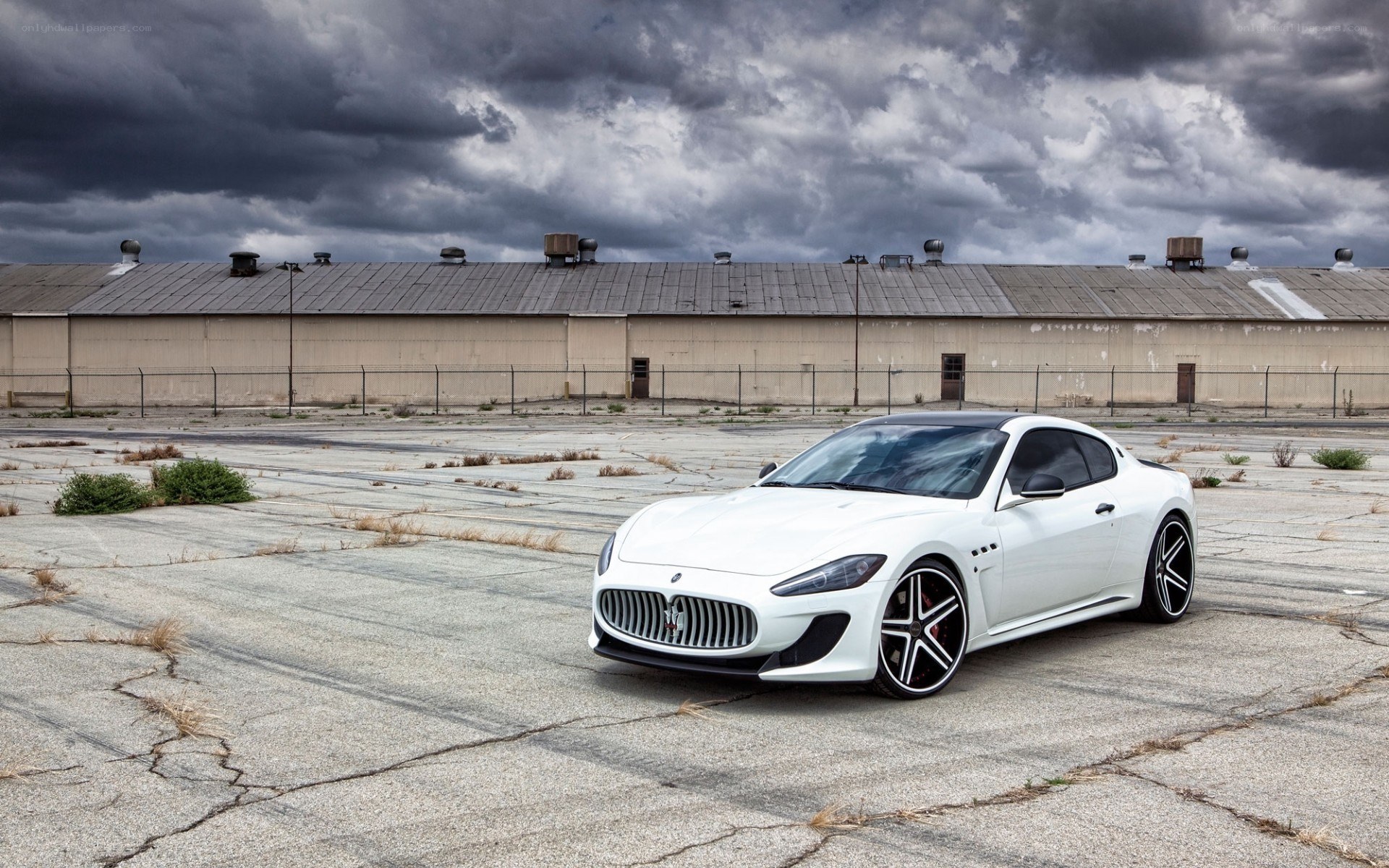 White Maserati on cracked pavement